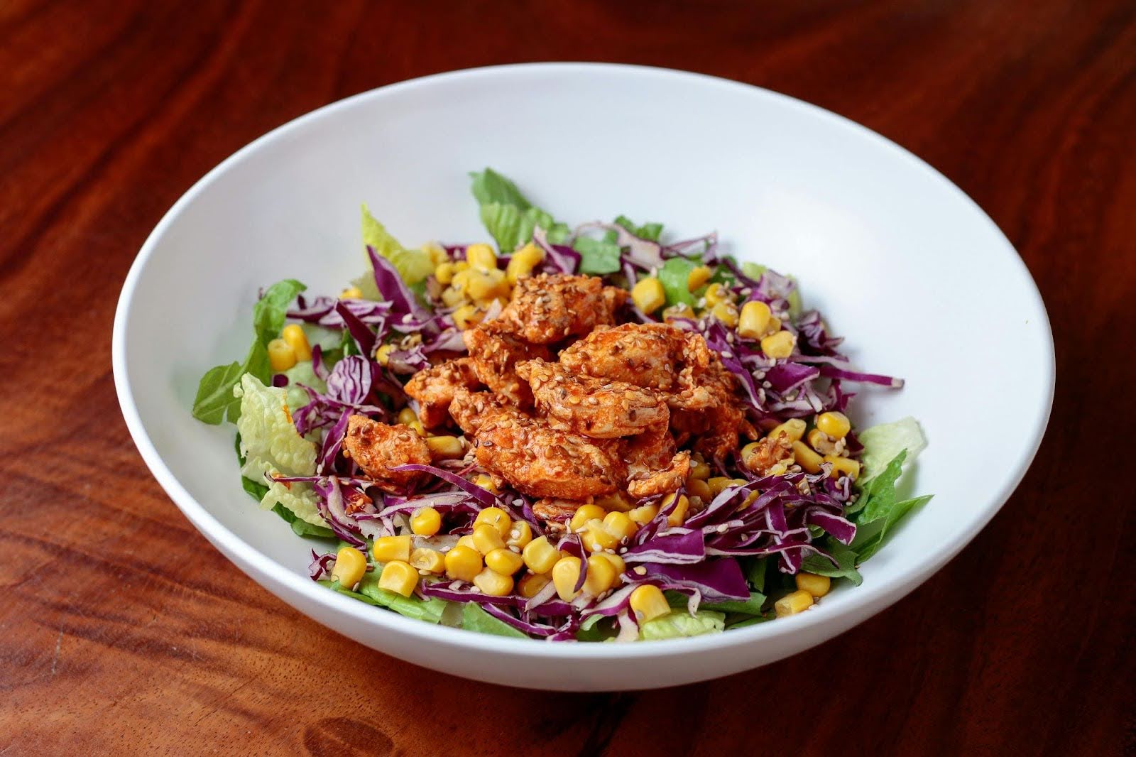 A colorful and healthy chicken salad, showcasing the fresh, chef-prepared dining at Rhoda Goldman Plaza.