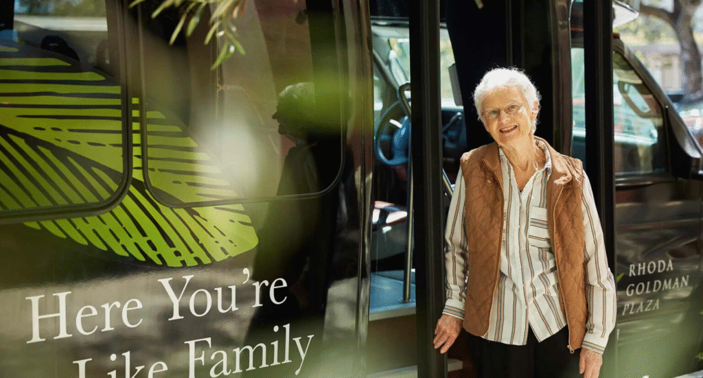 Resident standing by Rhoda Goldman Plaza shuttle, ready for an outing in San Francisco.