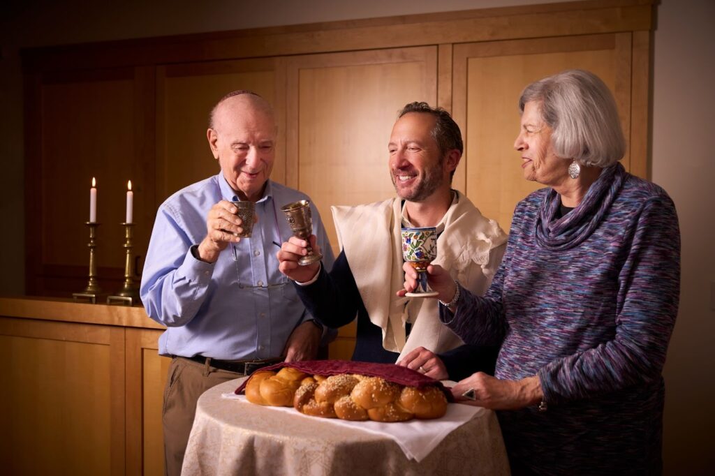 Rabbi Daniel Isaacson (Director of JFCS' Spiritual Care Services) with two residents at Rhoda Goldman Plaza